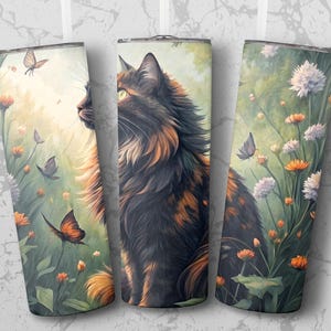 May include: Three stainless steel tumblers with a watercolor design featuring a tortoiseshell cat, butterflies, and flowers. The cat is the focal point, with a lush, detailed coat. The background includes orange and white flowers, and butterflies.