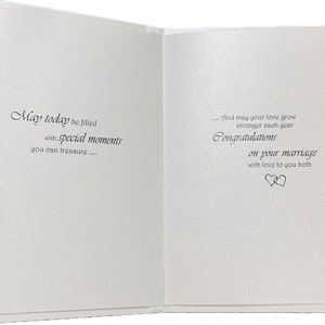 May include: Open wedding card with a textured, off-white surface. The left side reads "May today be filled with special moments you can treasure..." The right side says "Congratulations on your marriage" with a heart symbol.