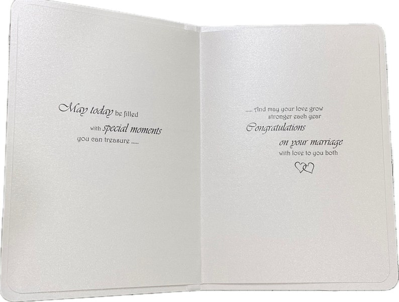 May include: Open wedding card with a textured, off-white surface. The left side reads "May today be filled with special moments you can treasure..." The right side says "Congratulations on your marriage" with a heart symbol.