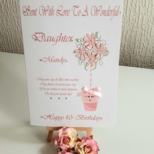 May include: A pink and white birthday card with a flower bouquet design and the text "Sent With Love To A Wonderful Daughter Mandy. May your day be filled with sunshine, May flowers be strewn your way You are wished so much happiness, On this your special day! Happy 40th Birthday."