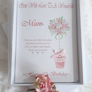 May include: A white card with pink lettering and a pink flower design. The card says "Sent With Love To A Wonderful Mum. May your day be filled with sunshine, May flowers be strewn your way, You are wished so much happiness, On this your special day! Happy Birthday."