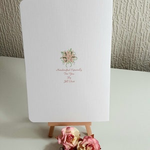 May include: A white card with a pink floral design and the text "Handcrafted Especially for You by Jill Grant".