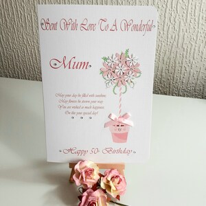 May include: A pink and white card with a flower bouquet design and the text "Sent With Love To A Wonderful Mum. May your day be filled with sunshine, May flowers be strewn your way, You are wished so much happiness, On this your special day! Happy 50th Birthday."