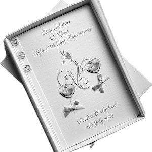 May include: A silver wedding anniversary card in a white box. The card features the text "Congratulations On Your Silver Wedding Anniversary". It has two heart-shaped ornaments with the names "Andrew" and "Pauline". The date "16th July 2025" is also printed.