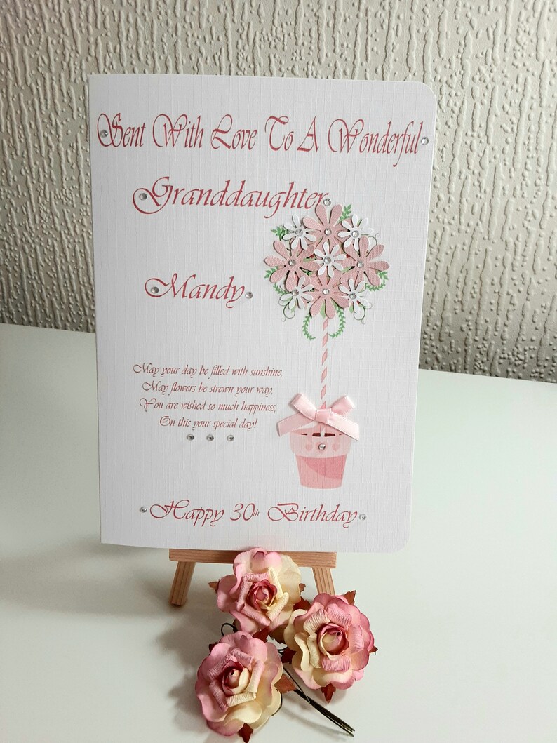 May include: A pink and white card with a flower bouquet design and the text "Sent With Love To A Wonderful Granddaughter Mandy. May your day be filled with sunshine, May flowers be strewn your way You are wished so much happiness, On this your special day! Happy 30th Birthday."