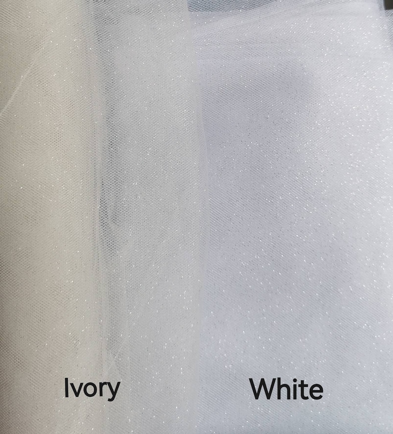 May include: Two swatches of tulle fabric, one ivory and one white, both with a subtle sparkle finish. The fabric is sheer and lightweight.