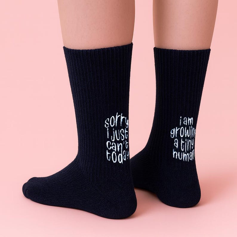 Socks with a light-hearted message for moms-to-be, celebrating the miraculous process of growing a tiny human.