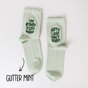 Socks with a light-hearted message for moms-to-be, celebrating the miraculous process of growing a tiny human.