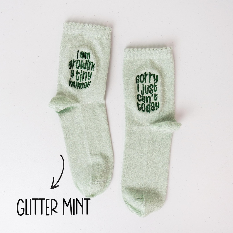 Socks with a light-hearted message for moms-to-be, celebrating the miraculous process of growing a tiny human.