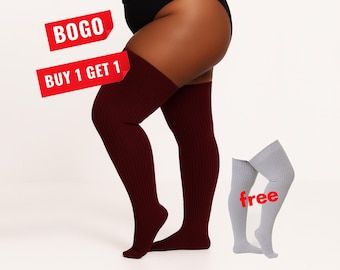 May include: A pair of dark maroon ribbed thigh-high socks worn on the legs, accompanied by a separate pair of light gray ribbed thigh-high socks. The image includes red text overlays that read BOGO, BUY 1 GET 1, and free.
