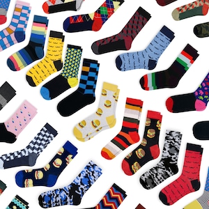 May include: A collection of colorful socks with various patterns, including argyle, stripes, and burger designs. The socks are in a variety of colors, such as blue, yellow, red, and black. The socks are made of a soft material and are suitable for everyday wear.