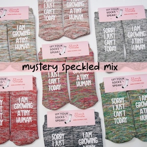 Socks with a light-hearted message for moms-to-be, celebrating the miraculous process of growing a tiny human.