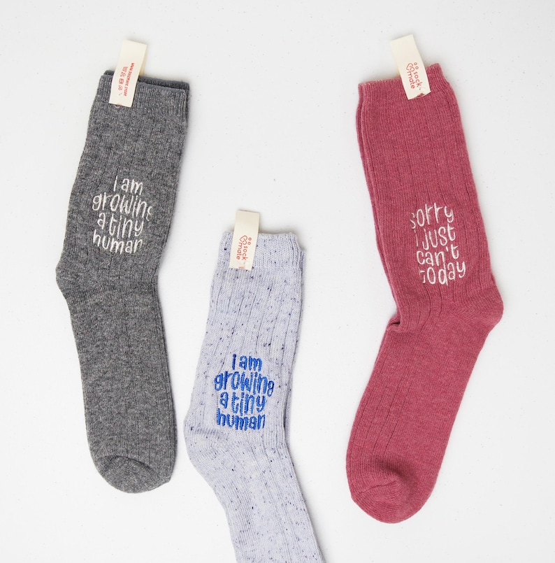 Heathered blue speckled crew socks with blue embroidery that says “Sorry I just can’t today.” Cozy ribbed cotton socks by Sockmate.