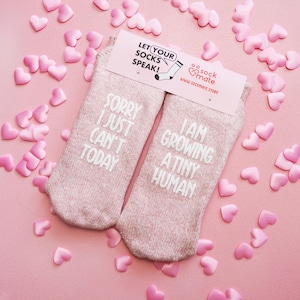 Comfortable socks featuring a witty phrase about pregnancy, capturing the transformative experience of growing a tiny human.