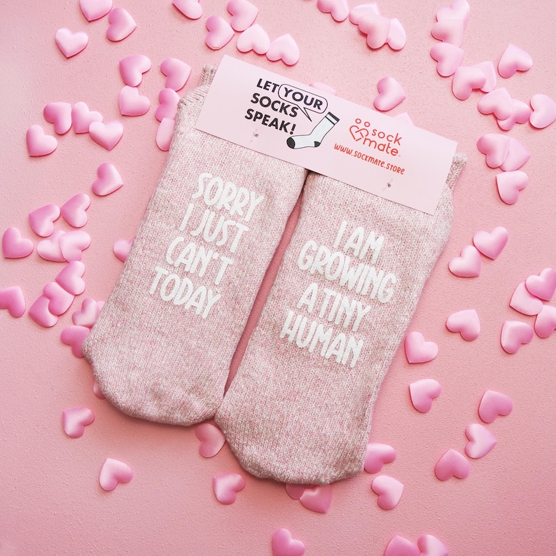 Comfortable socks featuring a witty phrase about pregnancy, capturing the transformative experience of growing a tiny human.