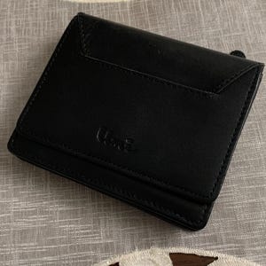 Cartera compacta vintage de cuero negro