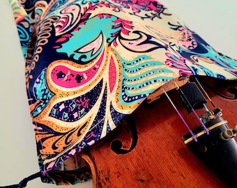 May include: A paisley patterned violin case with a drawstring closure, covering a wooden violin.