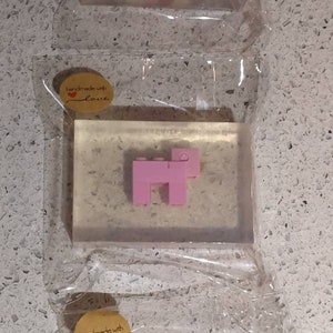 May include: Three clear rectangular bars of soap with a handmade with love label. Each bar features a different animal made of colorful Lego blocks. The first bar features a red and white cow, the second bar features a pink pig, and the third bar features a brown and white cow.