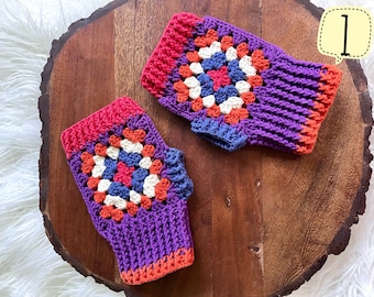 May include: A pair of crocheted fingerless gloves with a colourful granny square pattern in shades of purple, orange, red, white and blue. The gloves are on a wooden surface.