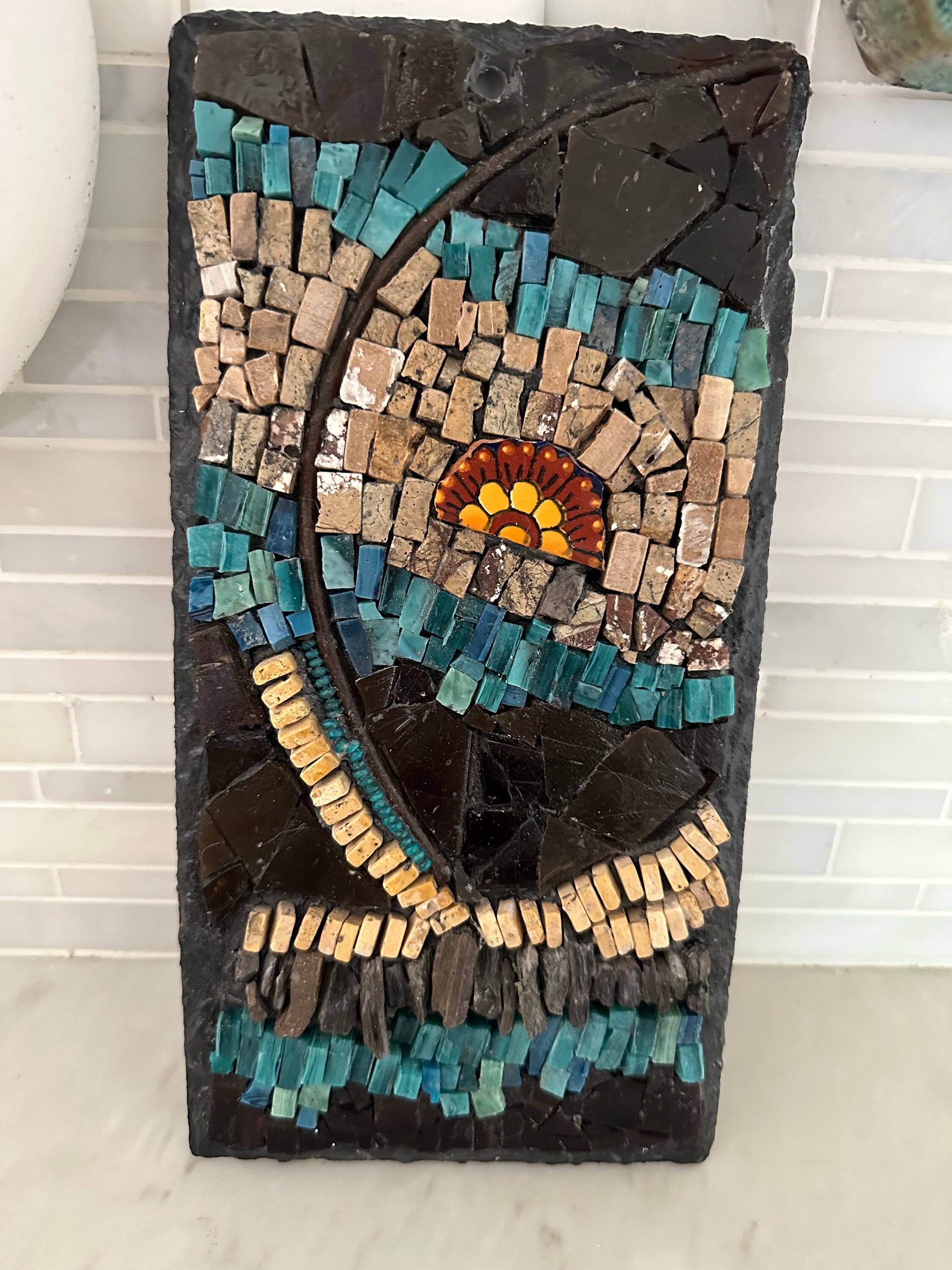 Mixed media mosaic on slate, turquoise & brown glass smalti, natural stone, metal, ceramic. Indoor/outdoor