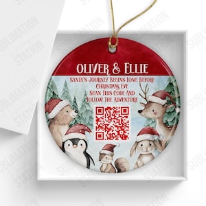 May include: A red and white Christmas bauble with a QR code and the text "Oliver & Ellie Santa's Journey Begins Long Before Christmas Eve Scan This Code And Follow The Adventure".