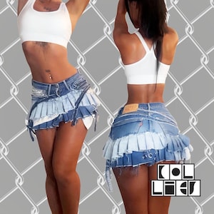 May include: A denim mini skirt with a layered, pleated design in shades of blue. The skirt features distressed edges and tie details. The image also shows a white crop top. The skirt has the text "COL LIES".
