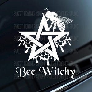 May include: A white vinyl decal featuring a five-pointed star overlaid with a honeybee and dripping honeycomb patterns. The text Bee Witchy is printed in a stylized serif font below the star design, creating a cohesive graphic element.