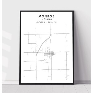 May include: A black and white line art map of Monroe, Indiana. The map shows the city's streets and roads. The text "Monroe, Indiana" and the coordinates "40.7450°N - 84.9369°W" are printed at the top of the map.