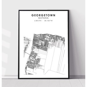May include: Black framed print featuring a detailed line drawing of Georgetown, Guyana. The city map is rendered in white against a white background. The city name and coordinates are printed at the top.