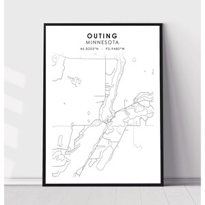 May include: A black and white line art map of Outing, Minnesota. The map shows the city's streets and waterways. The coordinates 46.8205°N - 93.9480°W are printed below the city name.