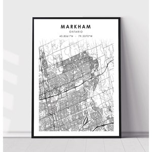 May include: Black and white map print of Markham, Ontario, Canada. The map shows the city's streets and neighborhoods. The text "MARKHAM ONTARIO 43.8561°N - 79.3370°W" is printed at the top of the map.