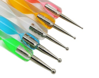 May include: Set of five nail art tools with different shaped tips. The tools have colorful, striped handles.