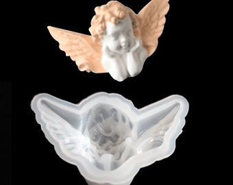 May include: A white silicone mold of a cherub angel with wings. The mold is designed to create resin crafts.