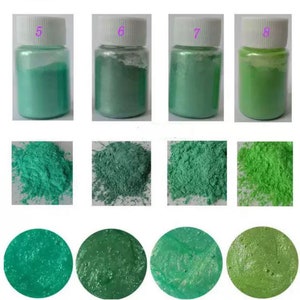 May include: Four small jars of green mica powder, labeled 5, 6, 7, and 8. The powder is shown in a loose pile, a compact pile, and a spread out layer.