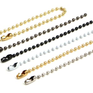 Könnte beinhalten: Fünf verschiedene Kugelketten-Stile mit einem Verschluss. Die Ketten sind gold, silber, schwarz, weiß und gunmetal.