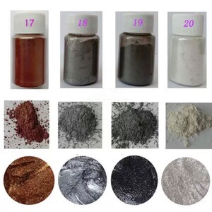 May include: Four small bottles of metallic pigment powder, labeled 17, 18, 19, and 20. The bottles contain red, silver, gray, and white powder. The powder is shown in a pile below each bottle.
