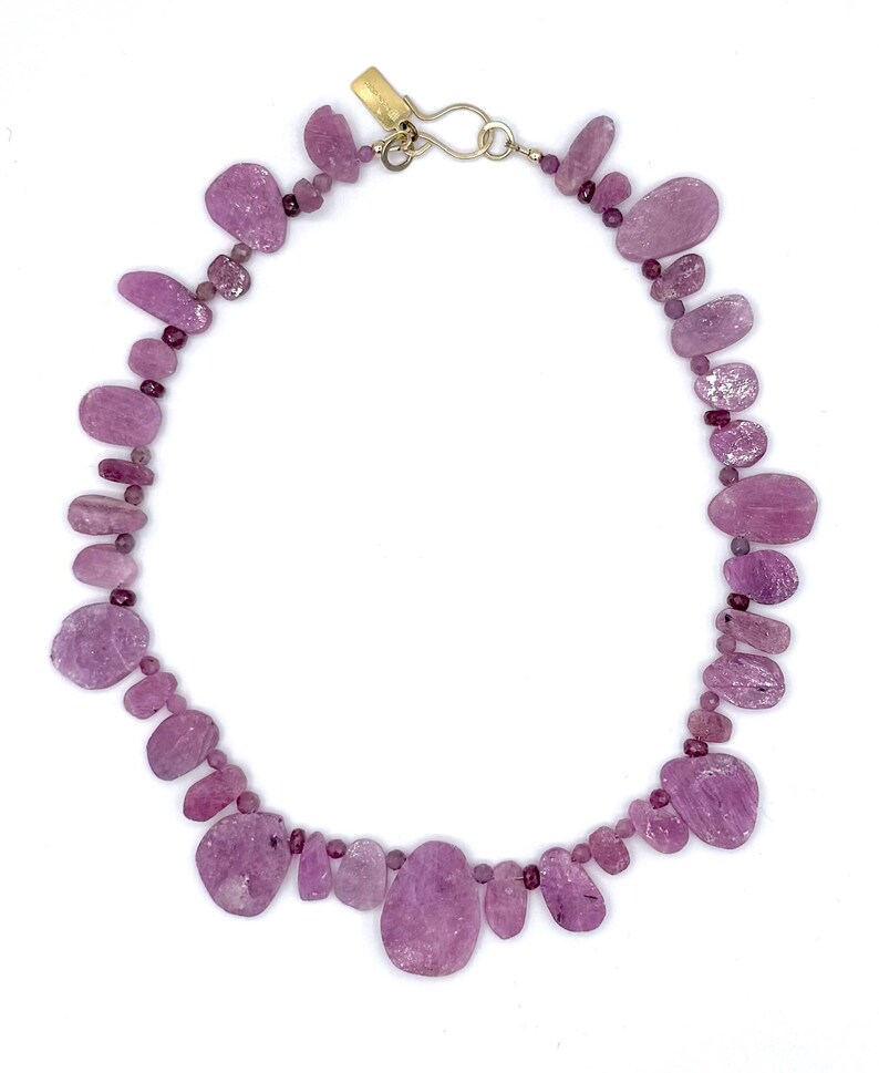 May include: A white ceramic mug with a black handle and the text "But First, Coffee" in a bold, black font. The mug is set against a neutral background, highlighting its simple design.