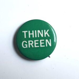 May include: A green button with the text "THINK GREEN" in white letters.