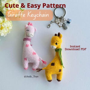 May include: Two crocheted giraffe keychains, one pink with pink heart spots and a pink bow, the other yellow with brown spots and a green scarf. The keychains are next to a silver keyring with charms. Text reads "Cute & Easy Pattern Giraffe Keychain".