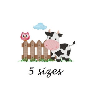 May include: An embroidered design of a cartoon cow with black patches, a pink nose, and an owl on a wooden fence. A blue cloud is above. The text "5 sizes" is below the image.