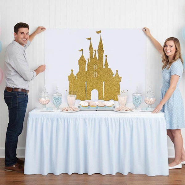 May include: A gold glitter castle silhouette on a white backdrop, displayed above a table with a light blue skirt. The table is set with treats and candy jars. Balloons in gold, pink, and blue are on either side.