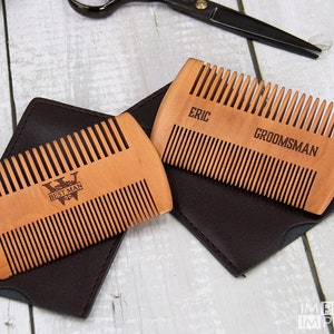 May include: Two wooden combs with leather cases. One comb is engraved with "Best Man" and a letter "W". The other comb is engraved with "Eric" and "Groomsman".