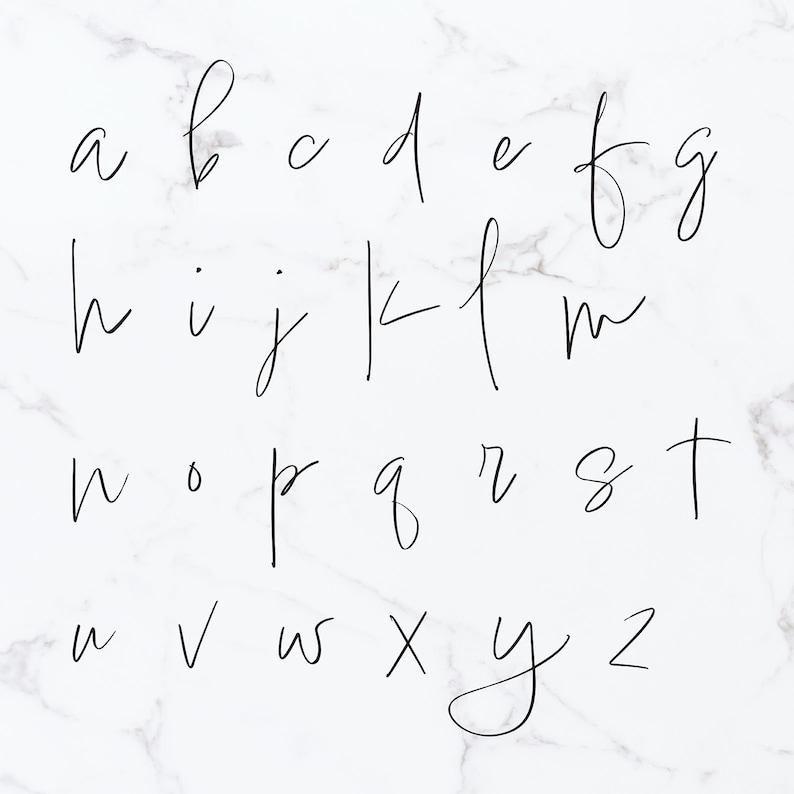 May include: A handwritten alphabet in black ink on a white marble background.