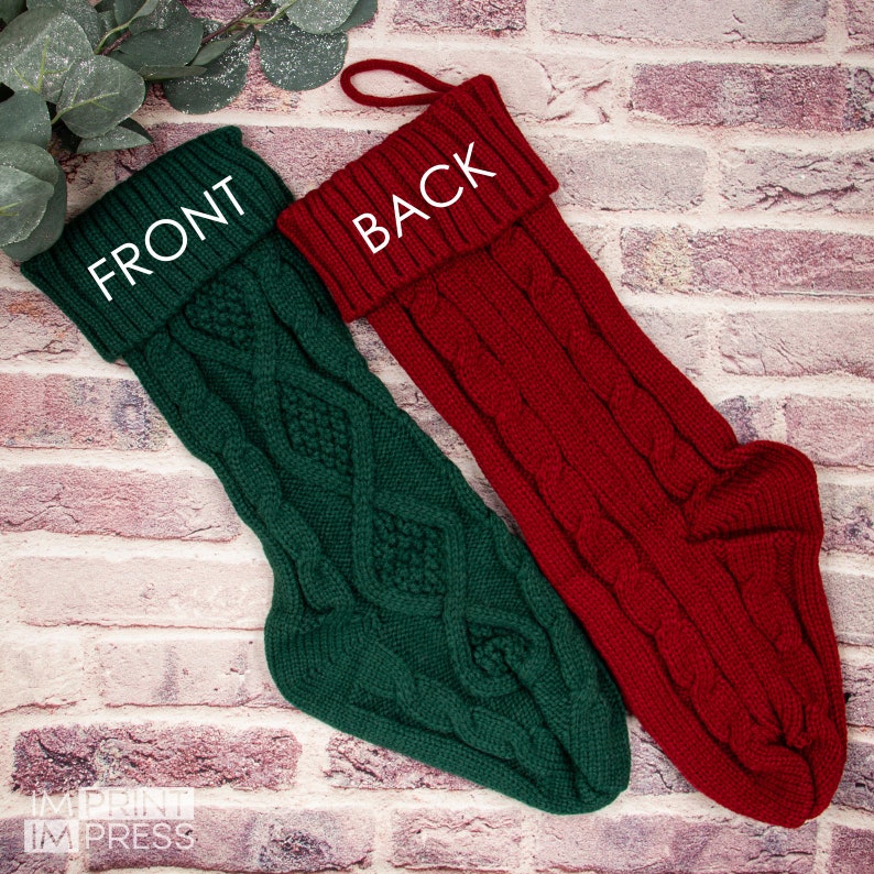 May include: Two Christmas stockings, one green and one red, with a cable knit pattern. The stockings have the words "FRONT" and "BACK" written on them.
