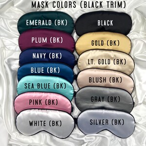 May include: A set of 12 sleep masks in various colors with black trim. The colors include emerald, black, plum, gold, navy, light gold, blue, blush, sea blue, gray, pink, white, and silver. Each mask has the color name and (BK) printed on it.