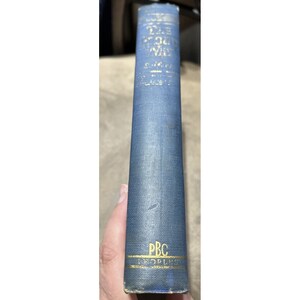 May include: A blue hardcover book with gold lettering on the spine. The title is "The Lost Colony" by  S.C. Gwynne. The book is part of the PBC  People's Book Club series.
