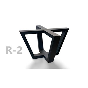 May include: Black metal table base with a geometric design. The base is shaped like a cross with four legs that extend out from the center. The base is labeled "R-2".