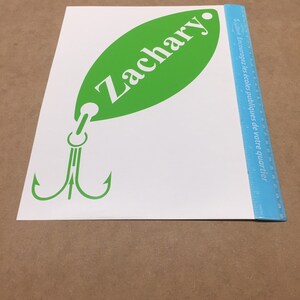 May include: Green and white vinyl decal of a fishing lure with the name Zachary on the lure.