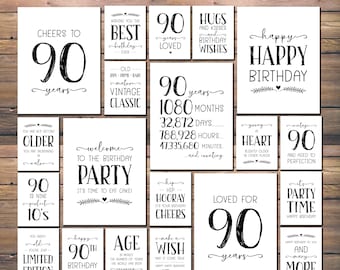 May include: A set of 12 printable signs with black text on a white background. The signs feature various messages celebrating a 90th birthday, including "Cheers to 90 years", "Loved for 90 years", "Happy 90th Birthday", and "Vintage Classic".