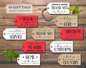 May include: Ten printable gift tags with patriotic themes. The tags are red, white, and brown with black text. The text includes phrases like "Thank You for Your Service", "You Are My Hero", and "Freedom Isn't Free".